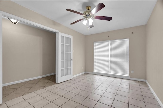 9715 Ballin David Dr, Spring, TX 77379 - spare room featuring light tile patterned flooring, a ceiling fan, baseboards, and french doors