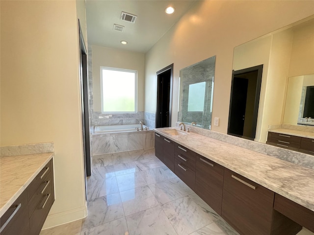 1844 Colquitt St, Houston, TX 77098 - bathroom with a garden tub, vanity, marble look tiles, and recessed lighting
