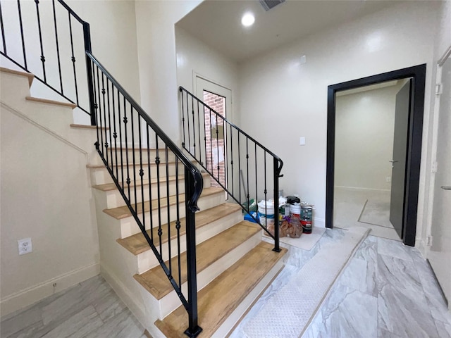 1844 Colquitt St, Houston, TX 77098 - stairs featuring baseboards, marble finish floors, and recessed lighting