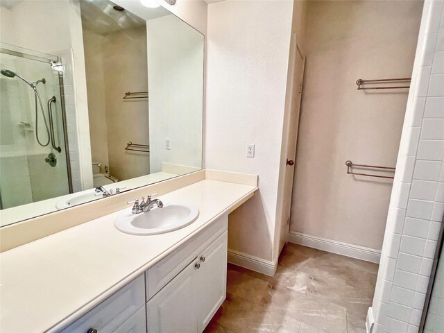 3130 Walnut Bend Ln Unit 409, Houston, TX 77042 - bathroom with a stall shower, vanity, toilet, and baseboards