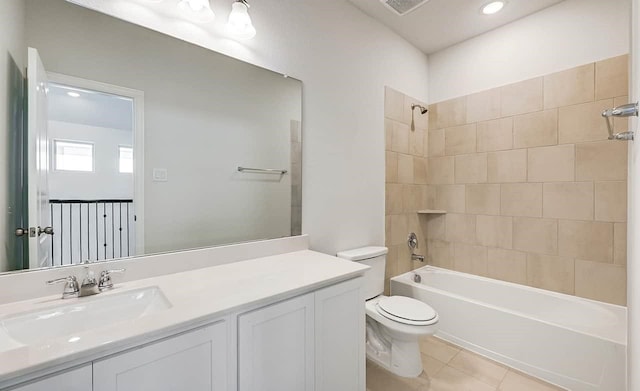 full bathroom with toilet, tile patterned flooring, vanity, and  shower combination