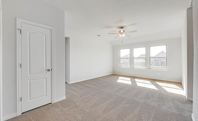unfurnished room featuring carpet, ceiling fan, and baseboards