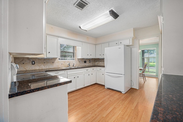 3823 Fernglade Dr, Houston, TX 77068 - kitchen featuring freestanding refrigerator, a sink, plenty of natural light, light wood-style floors, and a textured ceiling