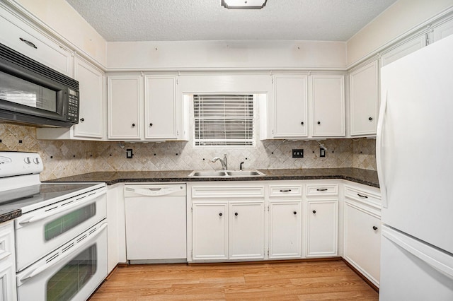 3823 Fernglade Dr, Houston, TX 77068 - kitchen featuring white appliances, a sink, dark countertops, light wood-type flooring, and a textured ceiling