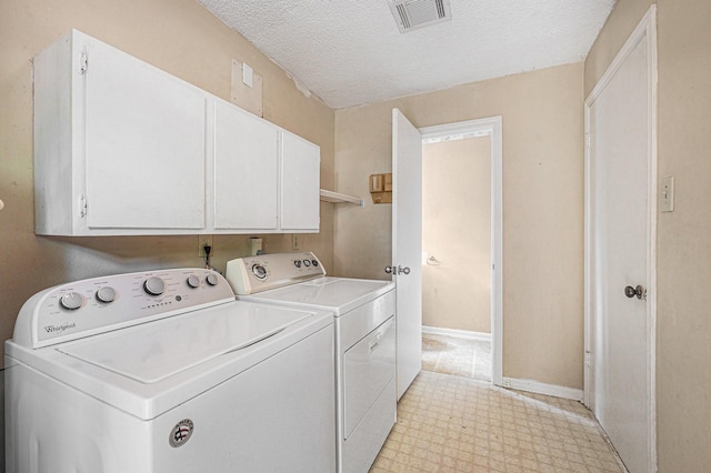 3823 Fernglade Dr, Houston, TX 77068 - washroom featuring washing machine and dryer, cabinet space, a textured ceiling, light floors, and baseboards