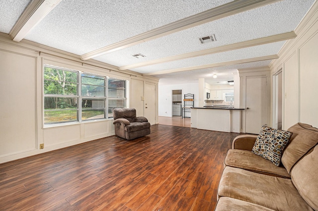 3823 Fernglade Dr, Houston, TX 77068 - living area featuring a textured ceiling, wood finished floors, a decorative wall, and beam ceiling