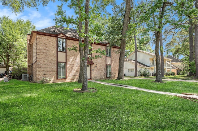 3823 Fernglade Dr, Houston, TX 77068 - view of front facade with brick siding, a front yard, and cooling unit
