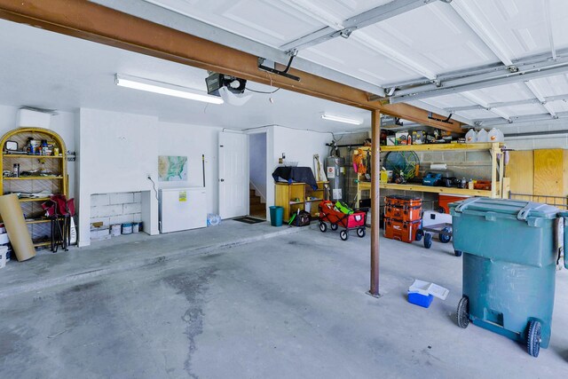 3100 75th St Unit 5, Galveston, TX 77551 - garage featuring a garage door opener and electric water heater