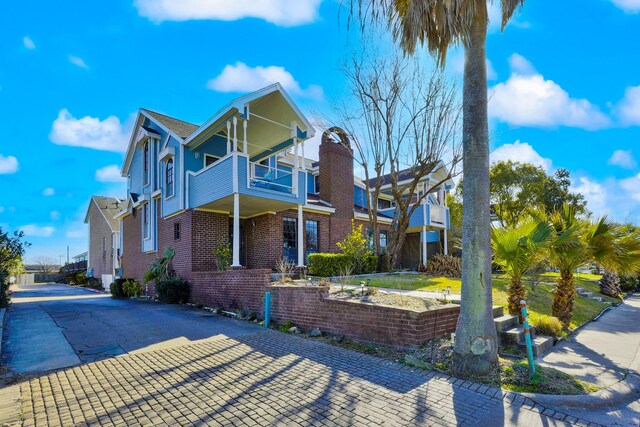 3100 75th St Unit 5, Galveston, TX 77551 - view of front of home featuring a balcony and brick siding