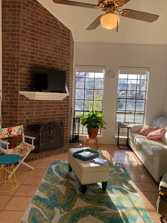 3100 75th St Unit 5, Galveston, TX 77551 - living room featuring tile patterned floors, vaulted ceiling, ceiling fan, and a brick fireplace