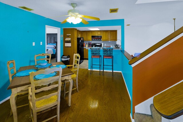 3100 75th St Unit 5, Galveston, TX 77551 - dining room featuring light wood-type flooring, ceiling fan, and stairway