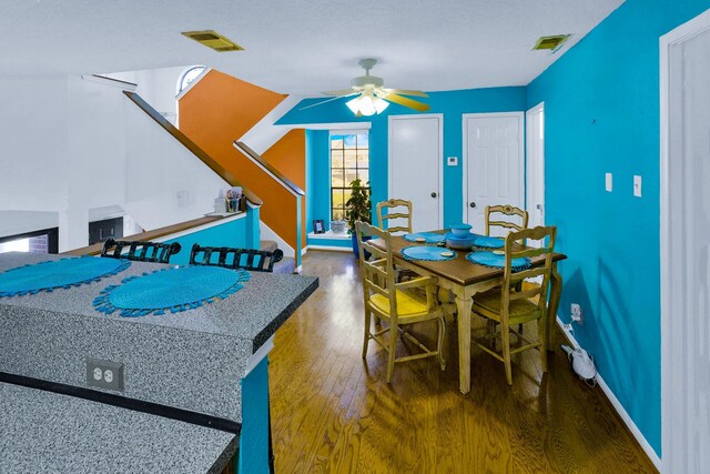 3100 75th St Unit 5, Galveston, TX 77551 - dining room featuring ceiling fan, wood finished floors, stairs, and baseboards