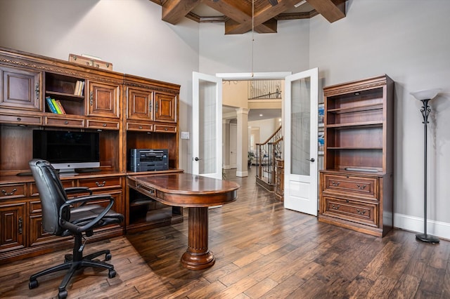 2919 Rutherford Place Ct, Katy, TX 77494 - office area with beam ceiling, baseboards, dark wood-style floors, a towering ceiling, and decorative columns