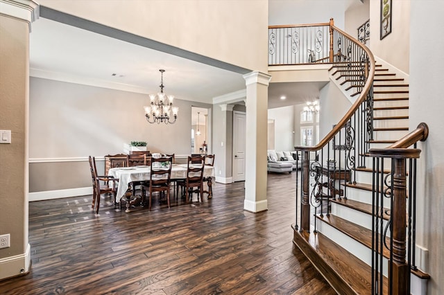 2919 Rutherford Place Ct, Katy, TX 77494 - dining space featuring a chandelier, stairway, wood finished floors, a towering ceiling, and ornamental molding