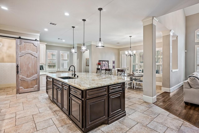 2919 Rutherford Place Ct, Katy, TX 77494 - kitchen with a sink, baseboards, a chandelier, light stone counters, and a center island with sink