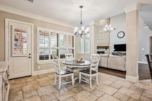 2919 Rutherford Place Ct, Katy, TX 77494 - dining room featuring a chandelier, baseboards, stone tile floors, ornamental molding, and a stone fireplace