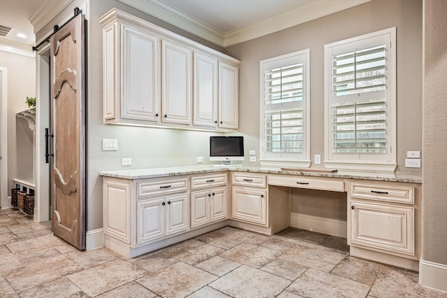 2919 Rutherford Place Ct, Katy, TX 77494 - kitchen with crown molding, stone tile flooring, a barn door, baseboards, and light stone countertops