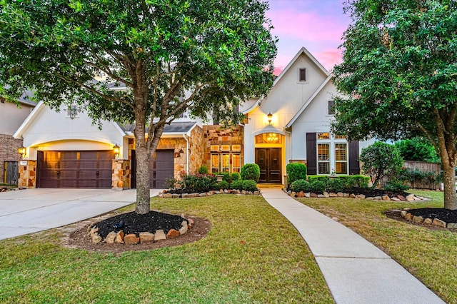 2919 Rutherford Place Ct, Katy, TX 77494 - view of front of house featuring a front lawn, driveway, stone siding, and stucco siding
