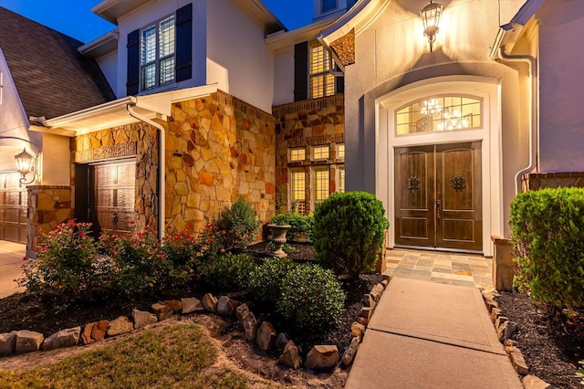 2919 Rutherford Place Ct, Katy, TX 77494 - view of exterior entry with stone siding, stucco siding, and a garage
