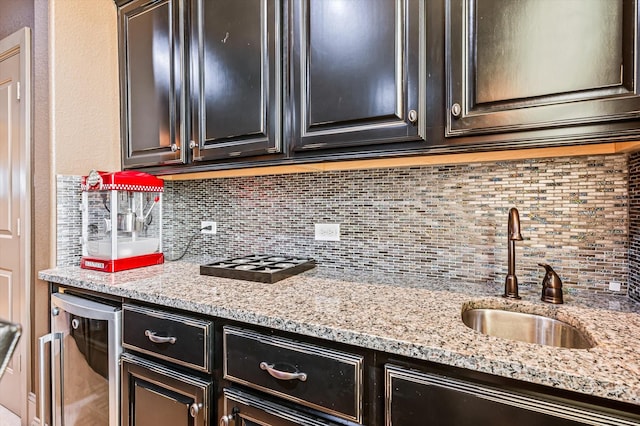 2919 Rutherford Place Ct, Katy, TX 77494 - kitchen featuring a sink, tasteful backsplash, and light stone countertops