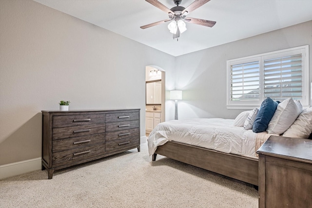 2919 Rutherford Place Ct, Katy, TX 77494 - bedroom featuring light colored carpet, connected bathroom, baseboards, arched walkways, and ceiling fan
