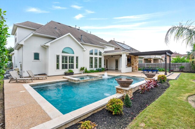 2919 Rutherford Place Ct, Katy, TX 77494 - back of house featuring a ceiling fan, a patio area, stucco siding, roof with shingles, and a pool with connected hot tub