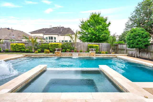 2919 Rutherford Place Ct, Katy, TX 77494 - view of swimming pool with a pool with connected hot tub and a fenced backyard