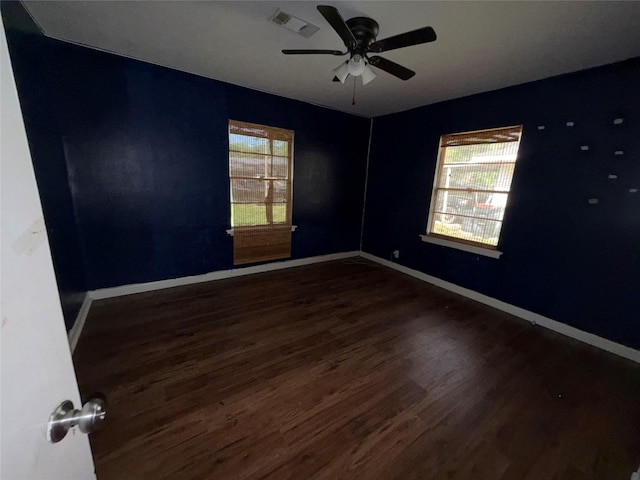 1307 Olive St, Baytown, TX 77520 - empty room with wood finished floors, healthy amount of natural light, a ceiling fan, and baseboards