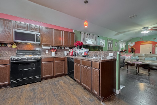 2902 Back Bay Brook Trl, Houston, TX 77045 - kitchen with black appliances, vaulted ceiling, a peninsula, dark wood-style flooring, and a sink