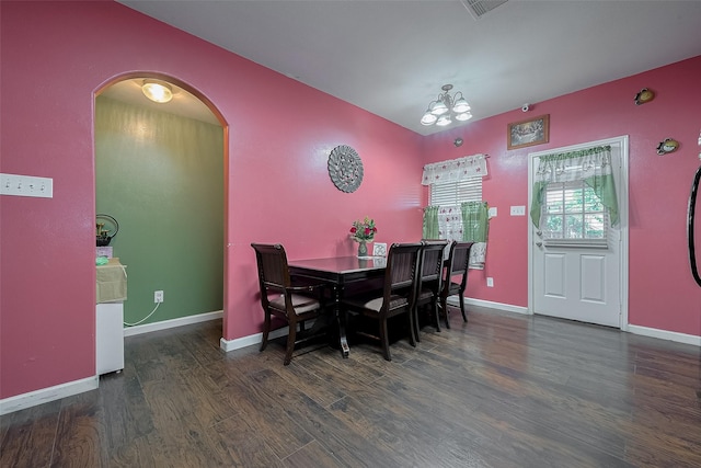 2902 Back Bay Brook Trl, Houston, TX 77045 - dining room with wood finished floors, arched walkways, a chandelier, and baseboards