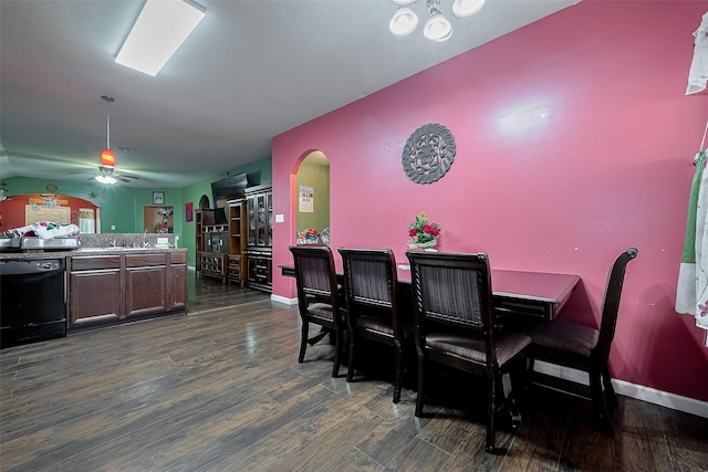 2902 Back Bay Brook Trl, Houston, TX 77045 - dining area with arched walkways, dark wood-style flooring, a ceiling fan, and baseboards