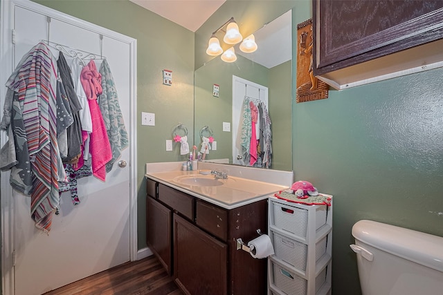 2902 Back Bay Brook Trl, Houston, TX 77045 - bathroom with toilet, wood finished floors, and vanity
