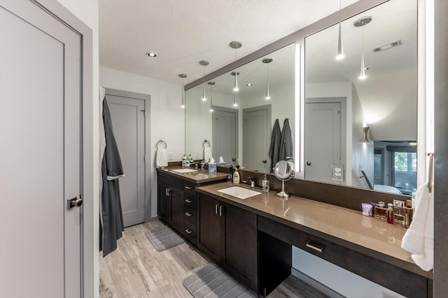 888 Cedar Ln, Livingston, TX 77351 - full bath featuring double vanity and wood finished floors