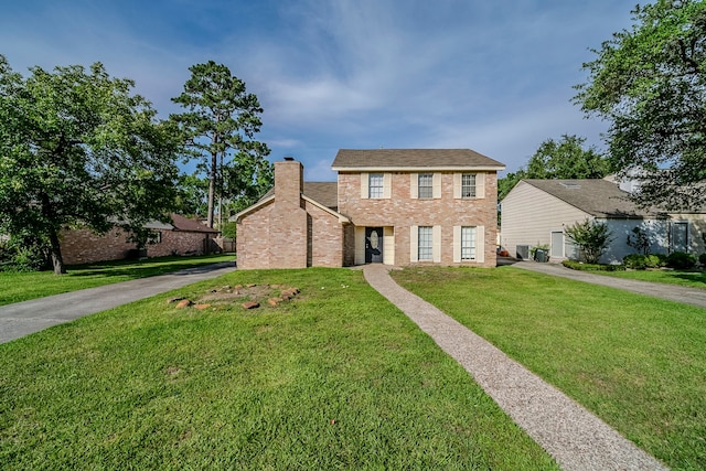 15714 Pebble Bend Dr, Houston, TX 77068 - view of front of house with a front yard, a chimney, and brick siding