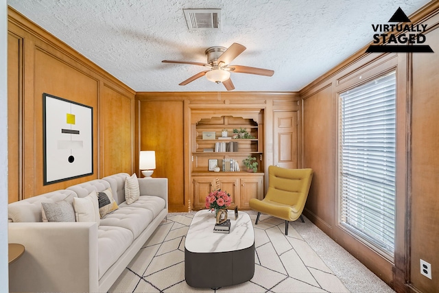 15714 Pebble Bend Dr, Houston, TX 77068 - living room with a ceiling fan, wooden walls, ornamental molding, and light tile patterned floors