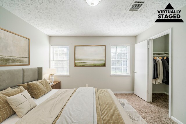 15714 Pebble Bend Dr, Houston, TX 77068 - bedroom featuring a spacious closet, multiple windows, carpet flooring, and baseboards