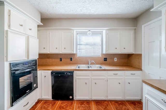 15714 Pebble Bend Dr, Houston, TX 77068 - kitchen featuring black appliances, a sink, white cabinets, light countertops, and a textured ceiling