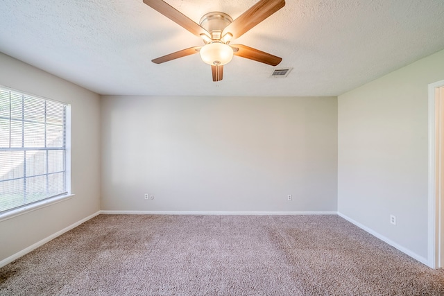 15714 Pebble Bend Dr, Houston, TX 77068 - empty room with carpet flooring, ceiling fan, baseboards, and a textured ceiling
