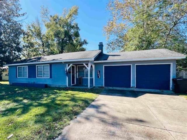1005 Lamar St, Vidor, TX 77662 - single story home featuring a garage, a front lawn, driveway, and a chimney
