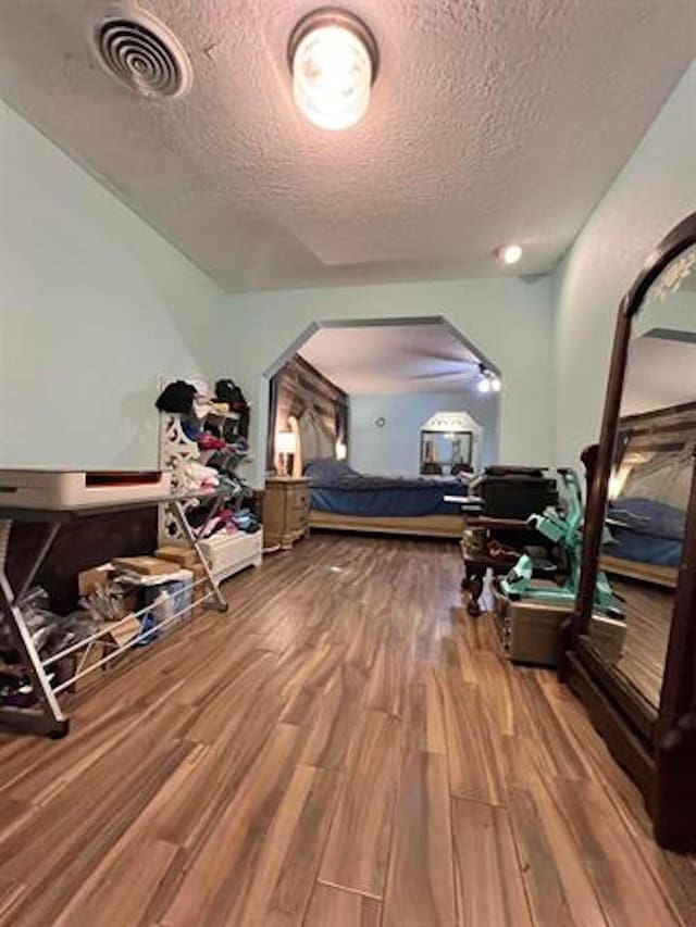 1005 Lamar St, Vidor, TX 77662 - bedroom with wood finished floors, a textured ceiling, and arched walkways
