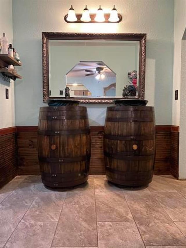 1005 Lamar St, Vidor, TX 77662 - detailed view of a ceiling fan, a wainscoted wall, and wood walls