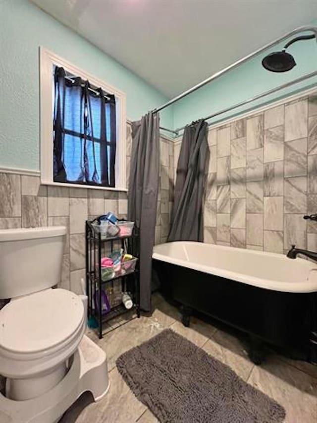 1005 Lamar St, Vidor, TX 77662 - full bathroom featuring toilet, tile walls, and a wainscoted wall