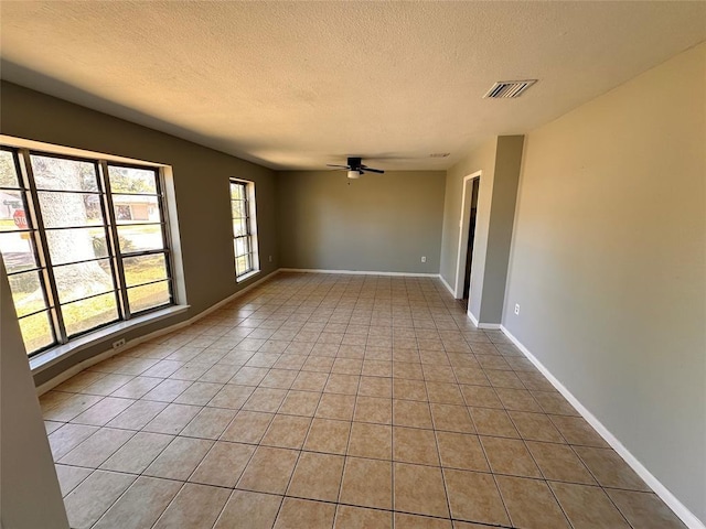 738 Beachcomber Ln, Houston, TX 77062 - unfurnished room featuring a textured ceiling, a ceiling fan, light tile patterned floors, and baseboards