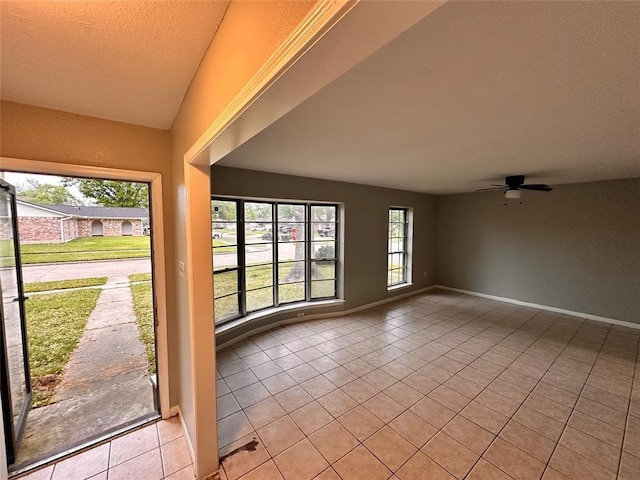 738 Beachcomber Ln, Houston, TX 77062 - spare room featuring light tile patterned floors, a ceiling fan, and baseboards