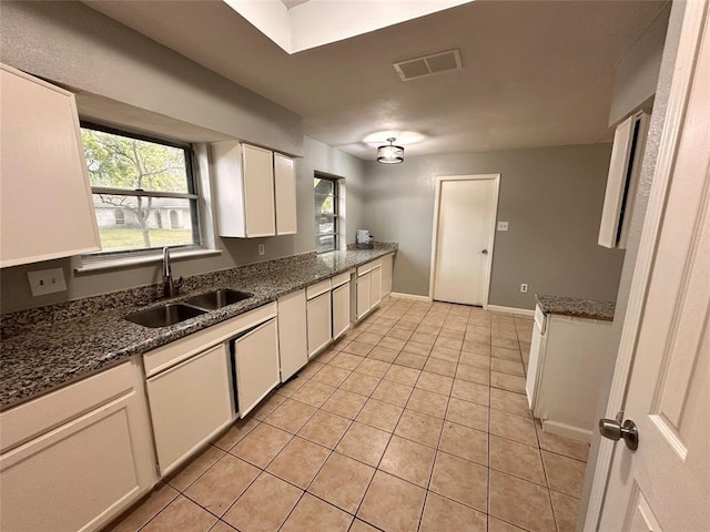 738 Beachcomber Ln, Houston, TX 77062 - kitchen featuring a sink, white cabinetry, light tile patterned floors, and dark stone counters