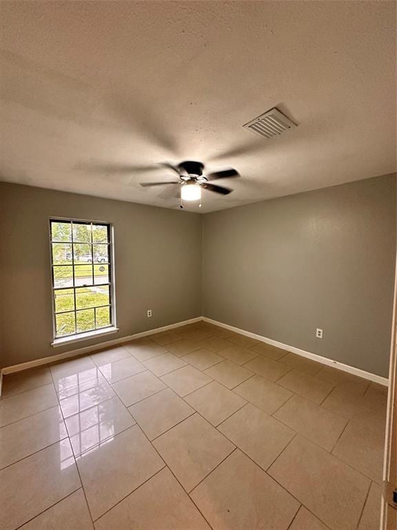 738 Beachcomber Ln, Houston, TX 77062 - spare room with light tile patterned floors, ceiling fan, baseboards, and a textured ceiling