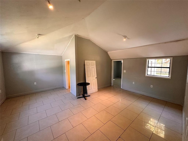 738 Beachcomber Ln, Houston, TX 77062 - additional living space with vaulted ceiling, light tile patterned flooring, and baseboards