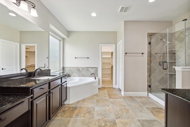 27208 Adrian Hills Ln, Spring, TX 77386 - bathroom with a stall shower, a garden tub, a spacious closet, and recessed lighting