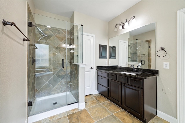 27208 Adrian Hills Ln, Spring, TX 77386 - bathroom featuring a stall shower, vanity, and baseboards