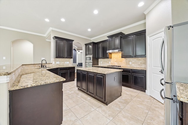 27208 Adrian Hills Ln, Spring, TX 77386 - kitchen with arched walkways, stainless steel appliances, a sink, backsplash, and recessed lighting